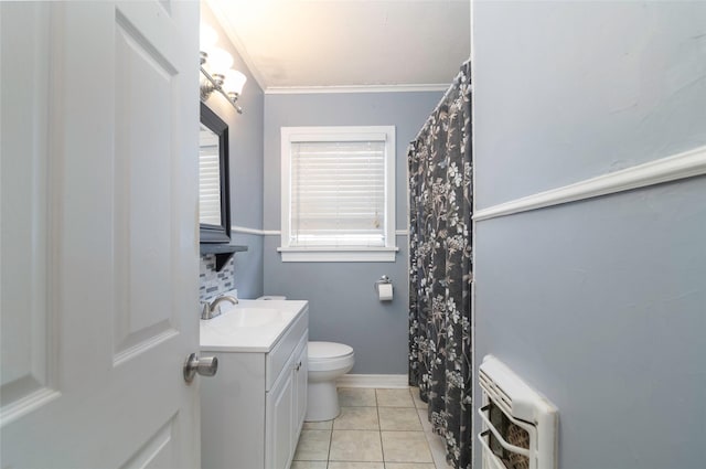 bathroom featuring toilet, tile patterned flooring, heating unit, ornamental molding, and vanity