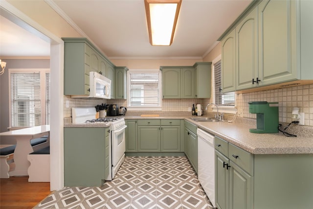 kitchen featuring a healthy amount of sunlight, sink, white appliances, and green cabinets