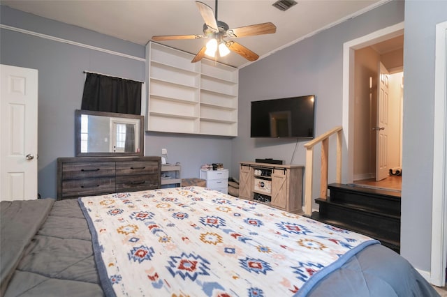 bedroom with ceiling fan and ornamental molding