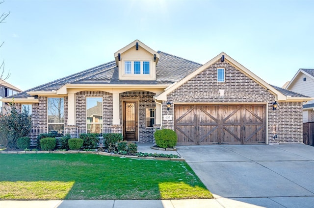 view of front of home featuring a front yard and a garage