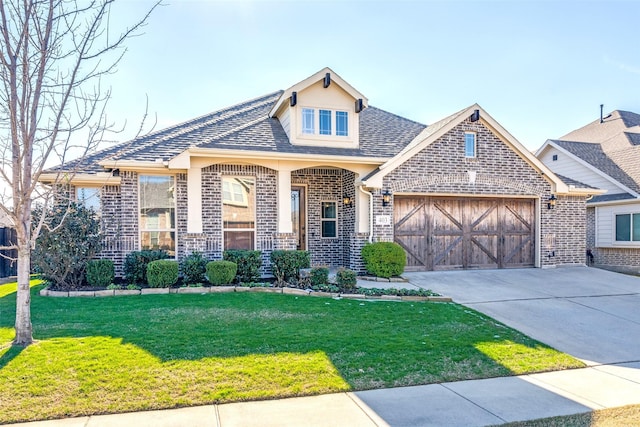 view of front facade with a garage and a front yard