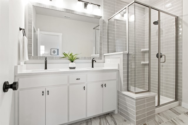 bathroom featuring an enclosed shower and vanity