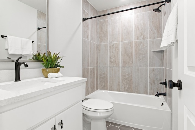 full bathroom featuring tiled shower / bath combo, vanity, tile patterned flooring, and toilet