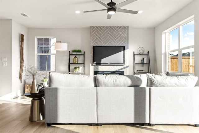 living room with ceiling fan and light hardwood / wood-style floors