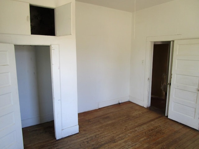 unfurnished bedroom featuring dark hardwood / wood-style flooring