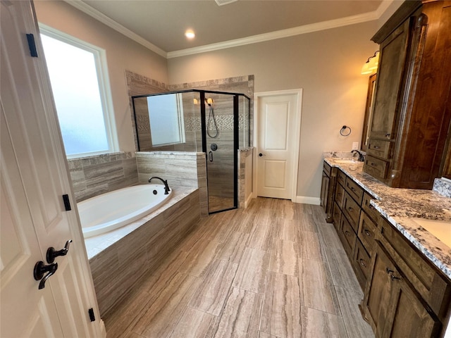 bathroom with vanity, crown molding, and separate shower and tub