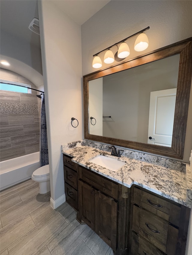 full bathroom with toilet, shower / bathtub combination with curtain, and vanity