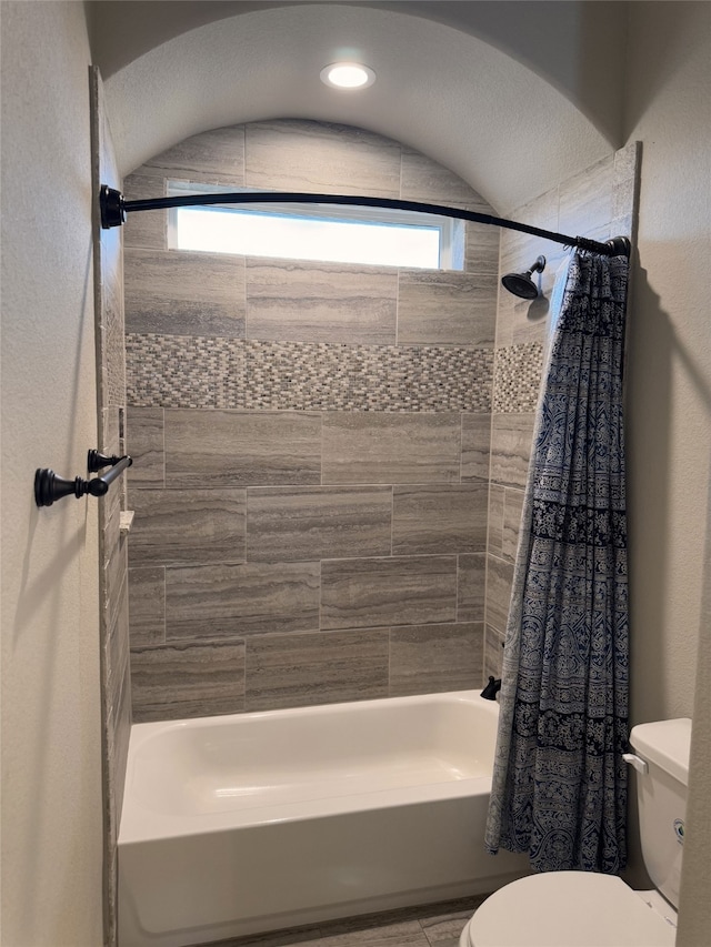 bathroom with toilet and shower / tub combo