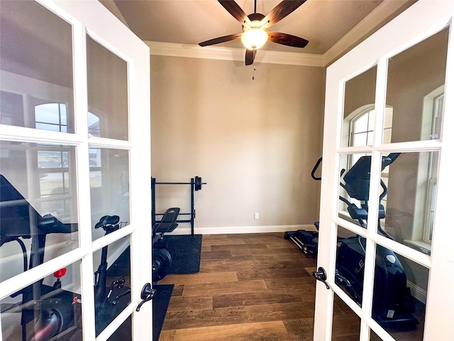 workout area featuring ceiling fan, french doors, dark wood-type flooring, and ornamental molding