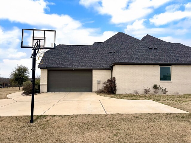 rear view of property featuring exterior kitchen, a patio area, and a lawn