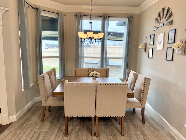 dining space featuring ornamental molding and a notable chandelier