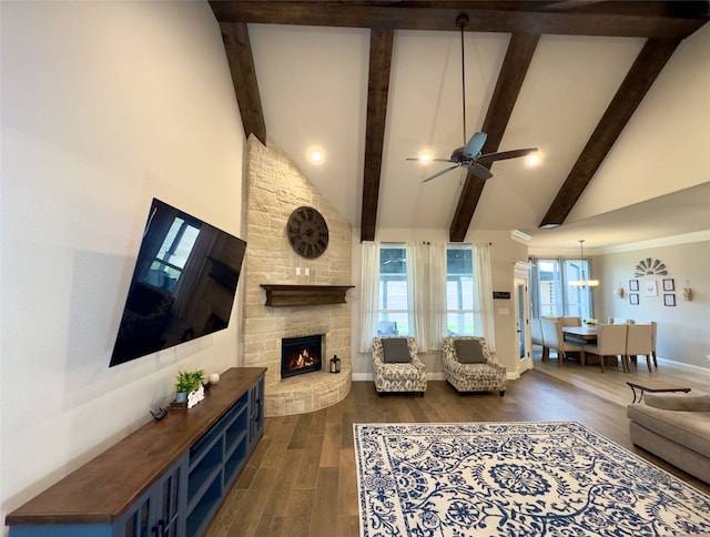 living room featuring ceiling fan, dark hardwood / wood-style flooring, a fireplace, and high vaulted ceiling