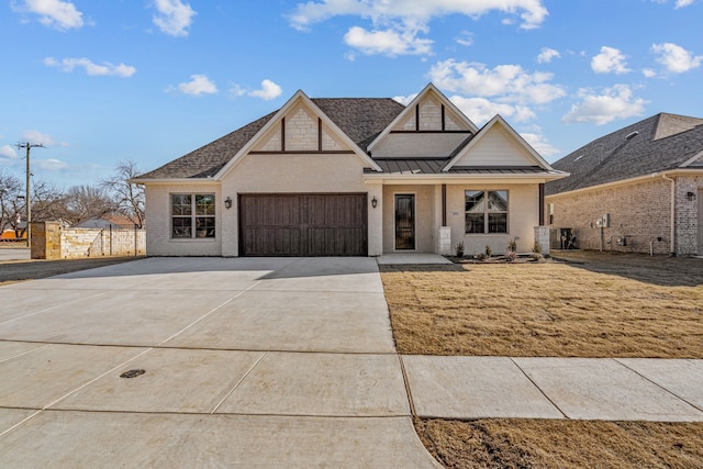 view of front of property with a garage and a front yard