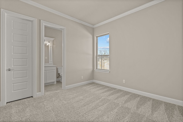 unfurnished bedroom with ensuite bath, ornamental molding, and light carpet