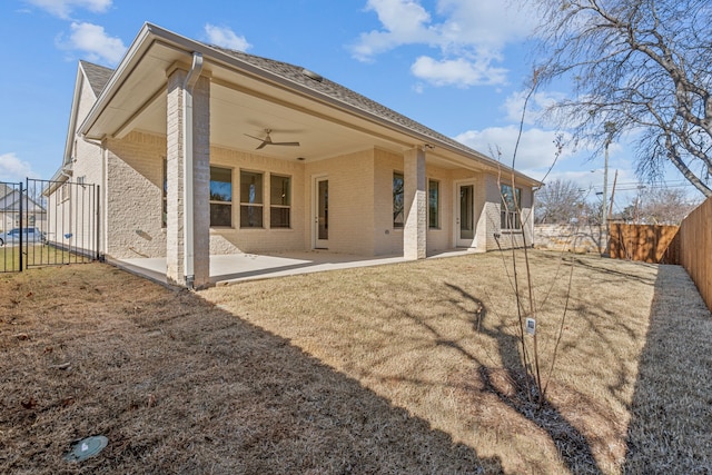 rear view of property with a patio, a yard, and ceiling fan