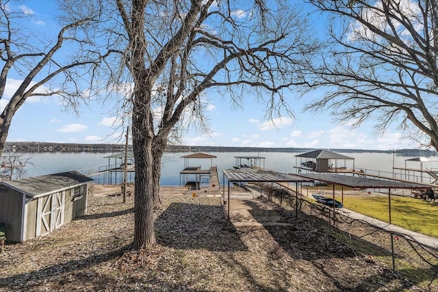 view of yard with a water view and a boat dock