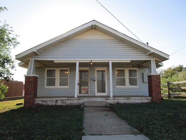 bungalow with a front yard and a porch