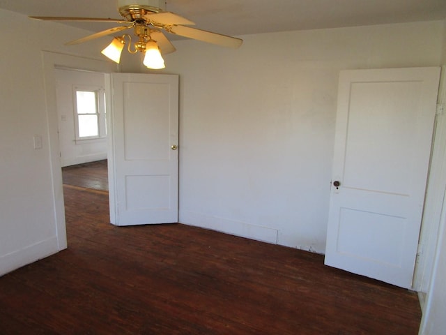 unfurnished room with ceiling fan and dark hardwood / wood-style floors