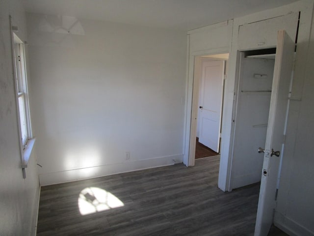 empty room with dark hardwood / wood-style floors