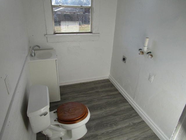 bathroom with toilet, wood-type flooring, and vanity