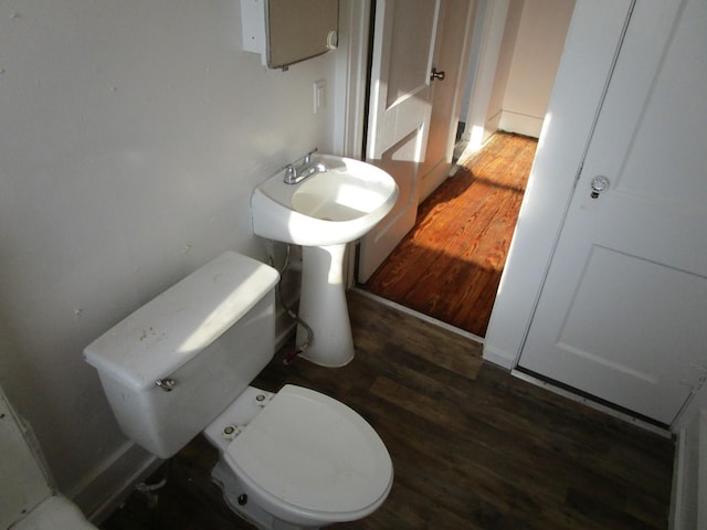 bathroom with hardwood / wood-style floors and toilet