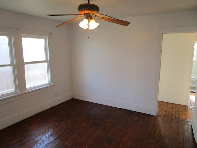 empty room featuring ceiling fan and dark hardwood / wood-style flooring