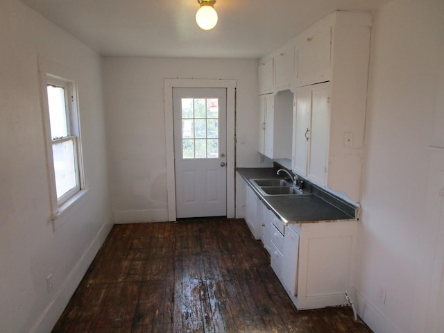 kitchen with sink, white cabinets, and dark hardwood / wood-style floors