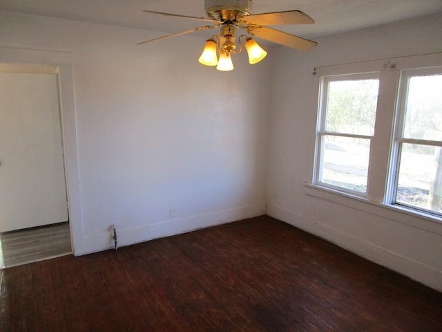 unfurnished room with ceiling fan and dark hardwood / wood-style floors