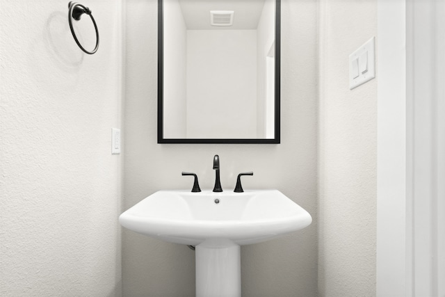 bathroom with visible vents and a sink