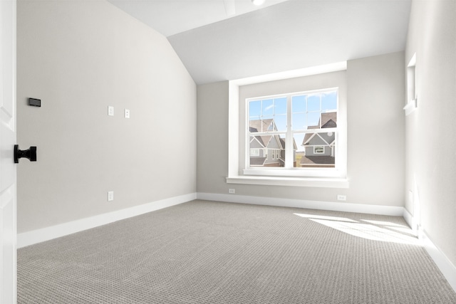 additional living space featuring vaulted ceiling, carpet, and baseboards