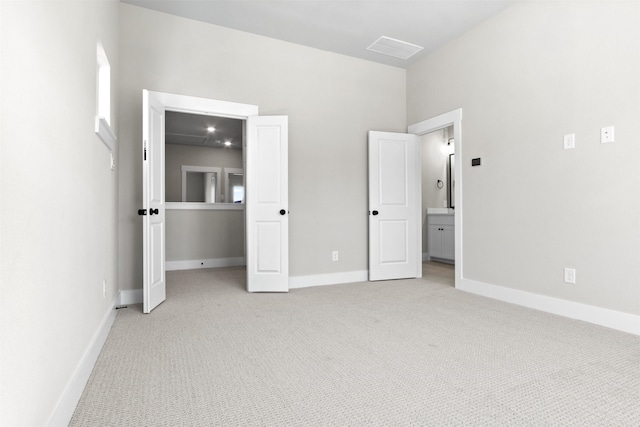 unfurnished bedroom with visible vents, baseboards, and light colored carpet