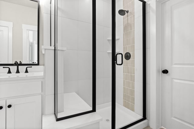 full bathroom featuring a stall shower and vanity