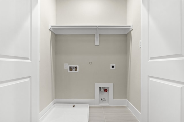 washroom with washer hookup, hookup for a gas dryer, hookup for an electric dryer, laundry area, and baseboards