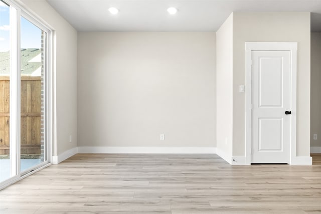 empty room featuring light wood-style floors and baseboards