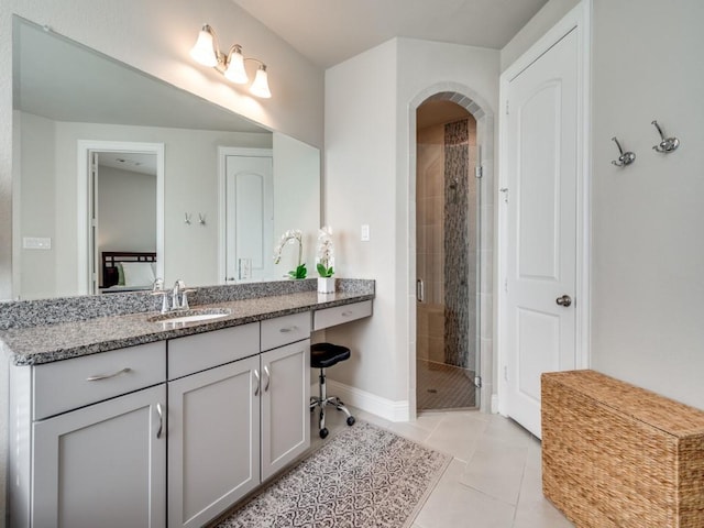 bathroom featuring an enclosed shower, vanity, and tile patterned flooring