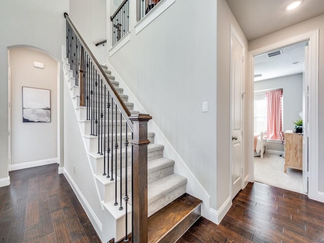 stairs featuring hardwood / wood-style floors