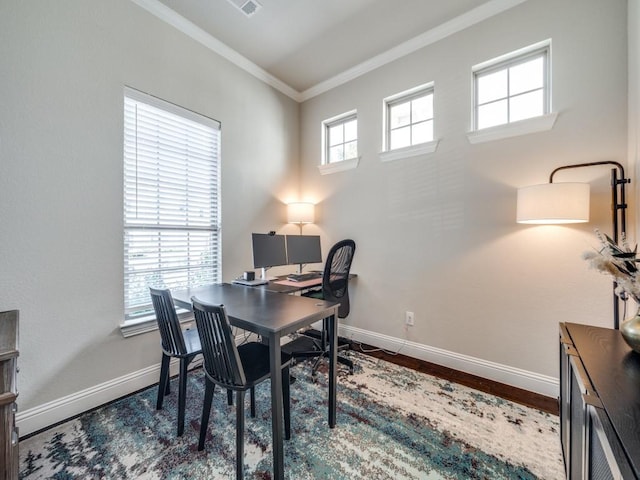 home office with plenty of natural light, dark hardwood / wood-style floors, and crown molding