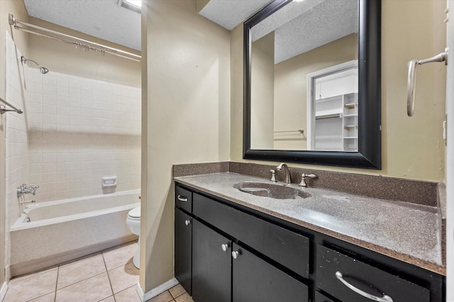 full bathroom with washtub / shower combination, toilet, a textured ceiling, vanity, and tile patterned flooring