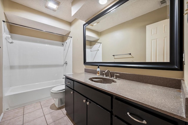 full bathroom featuring tile patterned flooring, vanity, toilet, a textured ceiling, and washtub / shower combination