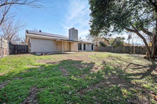 rear view of house with a yard and a patio area