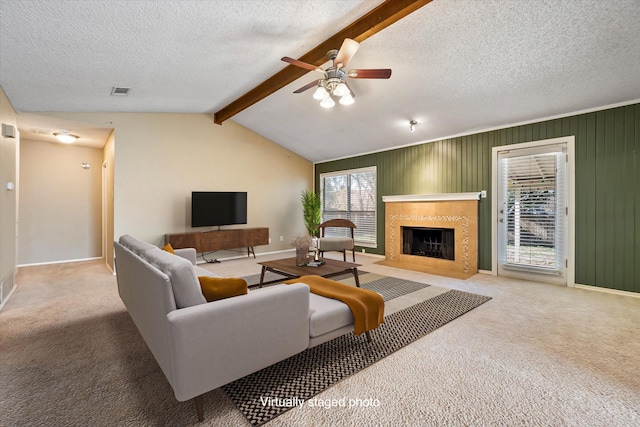 living room with light carpet, vaulted ceiling with beams, a textured ceiling, and ceiling fan