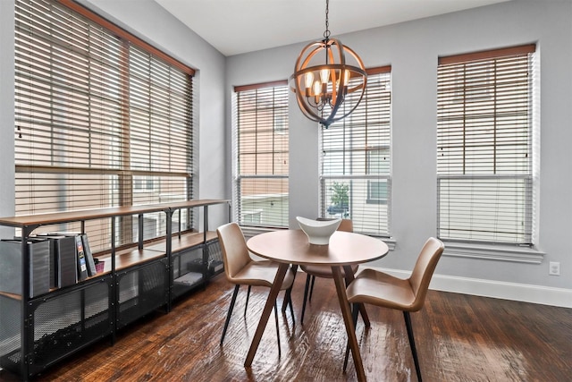 dining space featuring a wealth of natural light, a chandelier, and dark hardwood / wood-style floors