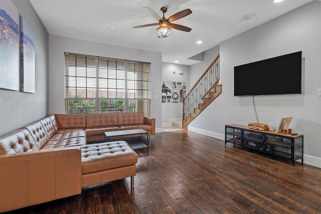 living room featuring ceiling fan and dark hardwood / wood-style floors