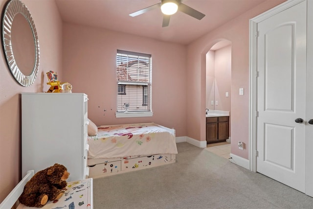 carpeted bedroom featuring ceiling fan, sink, and ensuite bathroom