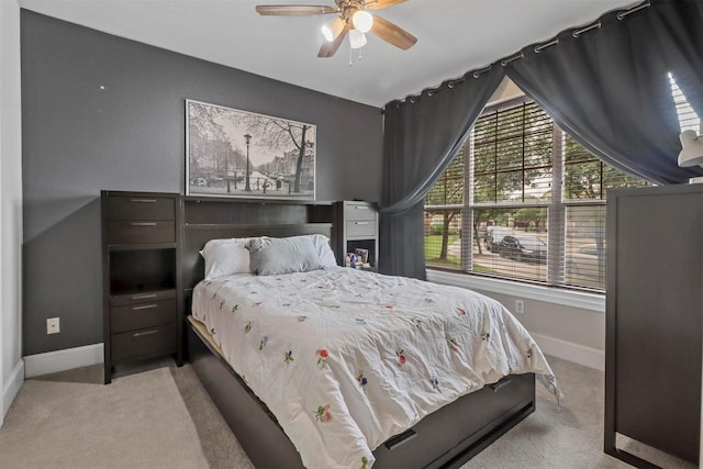 bedroom featuring light carpet and ceiling fan