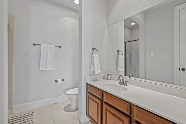 bathroom featuring a shower with shower door, tile patterned floors, vanity, and toilet