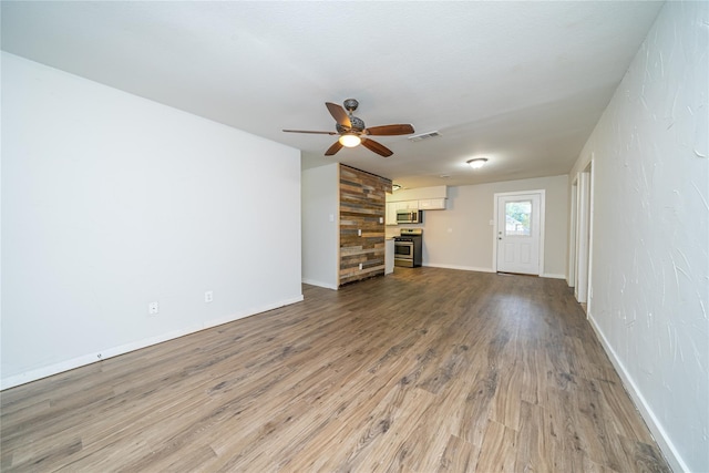 unfurnished living room featuring ceiling fan and wood-type flooring