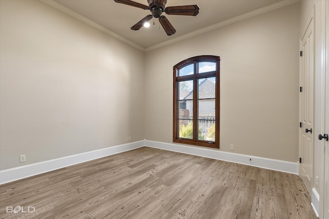 spare room featuring ceiling fan, light wood-type flooring, and crown molding