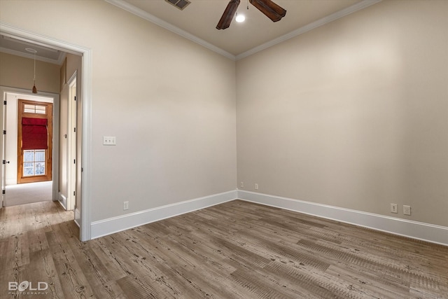 spare room with ceiling fan, wood-type flooring, and crown molding