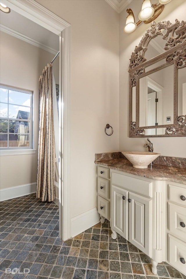 bathroom with vanity, ornamental molding, and curtained shower